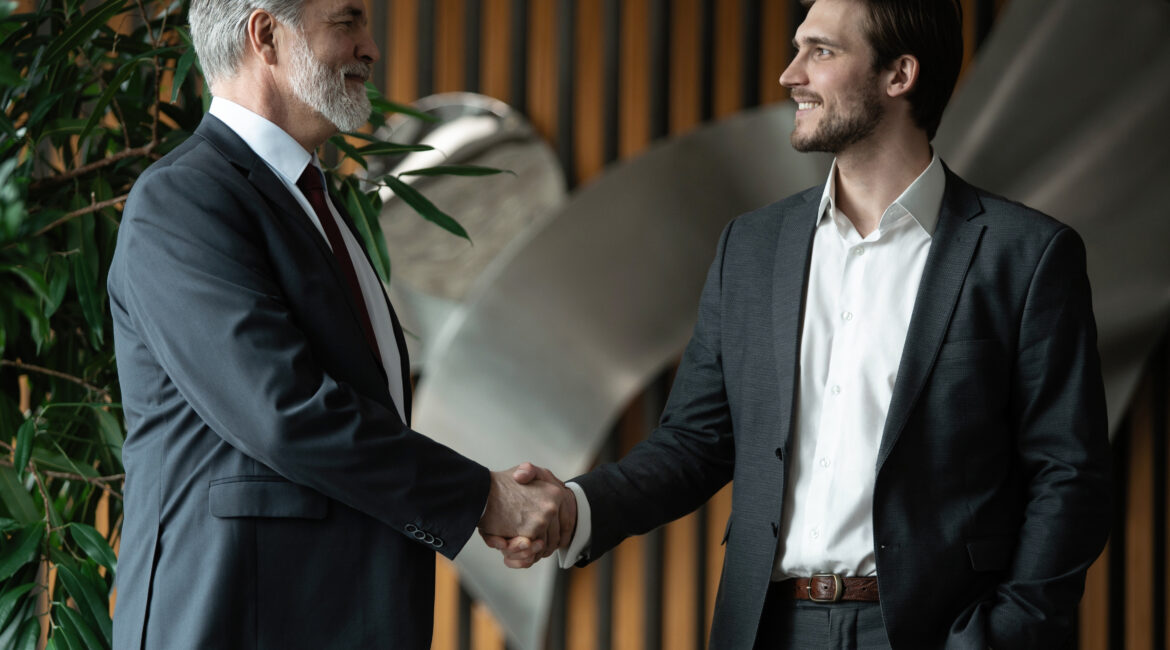 Getting hired two businessmen shaking hands