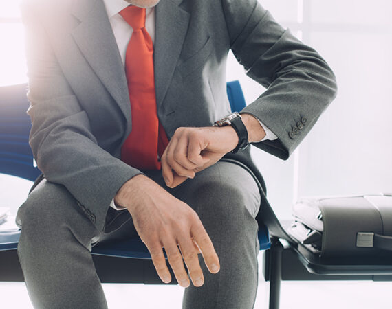 business man waiting for interview watching time long hiring process